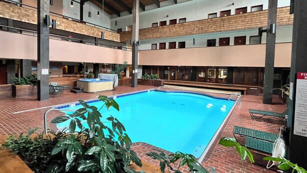 An indoor swimming pool with a hot tub, surrounded by brick flooring and potted plants. - 2 Bedroom 2 Bathroom Condo - Base Area - Three Seasons (Mount Crested Butte)