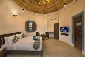 A hotel room with a bed, a desk, a television, and a wardrobe. - Lords Resort Chotila (Chotila)