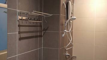 A modern bathroom with a toilet, sink, and shower.