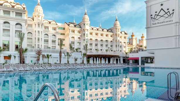 A luxurious hotel with a large pool, white balconies, and ornate architecture. - Side Royal Style Hotel (Manavgat)
