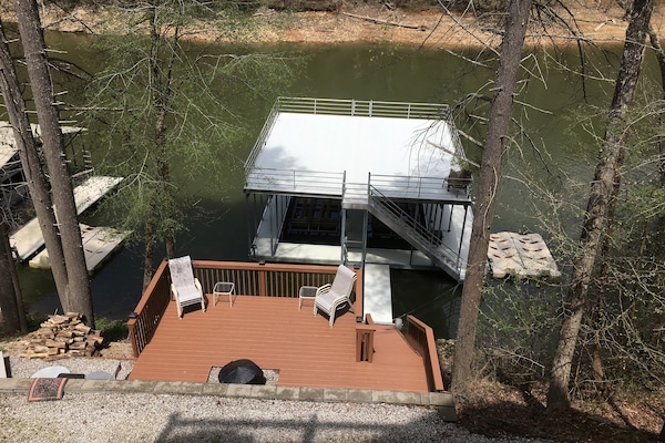 Firepit deck and dock shown in winter. Year round water in a quiet no wake cove