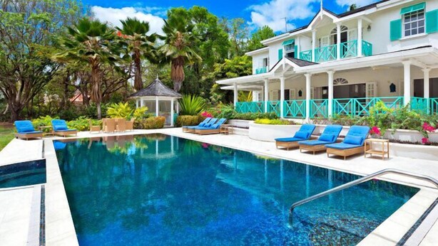 A pool area with lounge chairs and a gazebo. - Villa Moon Dance (Paynes Bay)