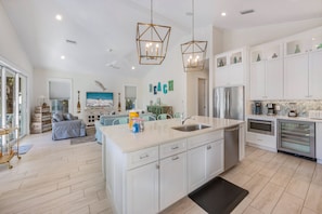 Enjoy cooking in this well-equipped kitchen with a large island, sink, and ample counter space.