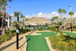 Play a round of golf amidst lush greenery and palm trees in a tropical setting.