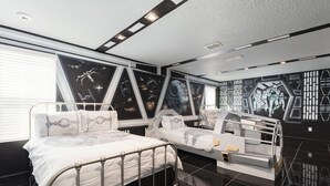 A bedroom with two beds, a large window, and Star Wars-themed wall art. - Modern Luxury Villa with Everything (Kissimmee)