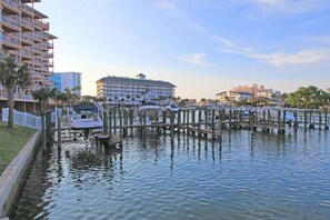 A marina with boats docked, a hotel building, and a waterfront promenade. - Penthouse w/Designer Décor! 806 Harborview Grande (Clearwater)