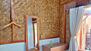 A room with a wooden desk, a mirror, and a hanging coat rack. - Cianjur Paddies Hostel (Cianjur)