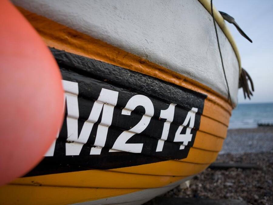 A close-up of a boat with the number "M214" on its side.