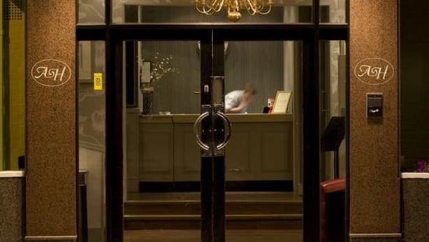 The exterior of a hotel named 'ARDINGTON' with a modern entrance featuring glass doors and a prominent sign. - Ardington Hotel (Worthing)