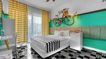 A modern bedroom with a bed, a bedside table, a mirror, and a bicycle wall decoration.