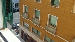 A multi-story building with a brick facade, multiple windows, and balconies. - Biancoreroma B&B (Rome)