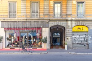 A storefront with a bicycle parked outside, a storefront with a bicycle parked outside, and a storefront with a bicycle parked outside. - notaMi - Tailors' Home Sempione (Milan)