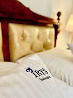 A bed with a headboard and pillows.