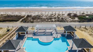 A pool area with a view of the beach and ocean. - LegaSea | Private Beach Access, Pool + Hot Tub! (North Topsail Beach)