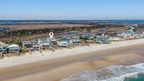 An aerial view of a coastal residential area with beachfront properties, including houses with ocean views and a sandy beach. - LegaSea | Private Beach Access, Pool + Hot Tub! (North Topsail Beach)