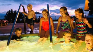 A group of children in a swimming pool area with a sunset in the background. - Del Mar Beaches~Luxury Ocean View Townhouse! (Del Mar)
