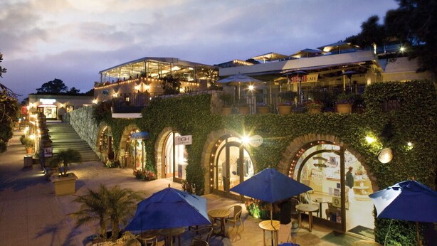 A hotel with outdoor seating, a staircase leading to upper floors, and a sign for 'SGH'. - Del Mar Beaches~Luxury Ocean View Townhouse! (Del Mar)
