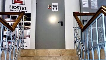 A hostel entrance with a sign indicating a 1.5m height clearance.