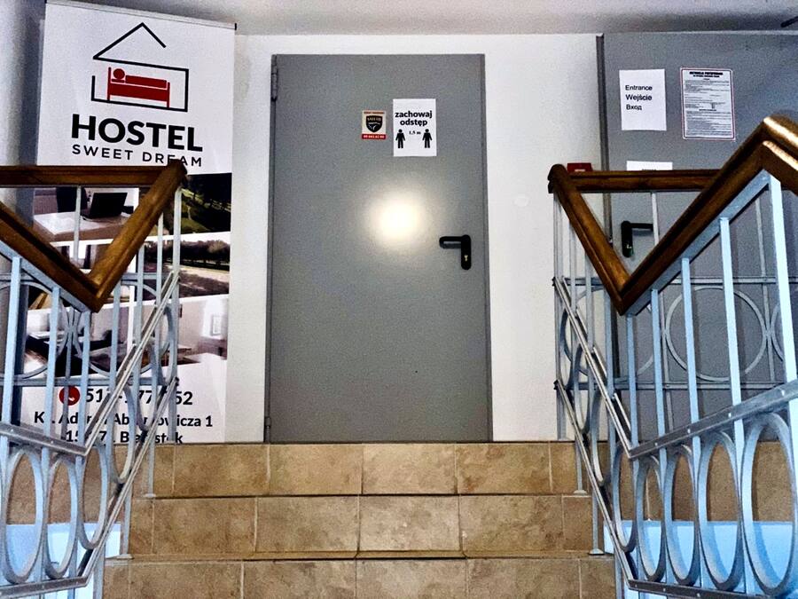 A hostel entrance with a sign indicating a 1.5m height clearance.