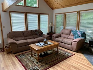 A living room with two sofas, a coffee table, and a patterned rug. - Zigadeaux - Hot Tub, Wood Burning Fireplace (Davis)