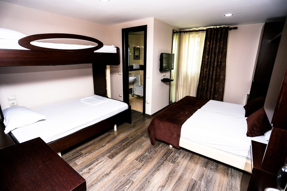 quadruple room | desk, laptop workspace, blackout curtains, soundproofing