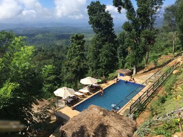 Outdoor pool, open 6:00 AM to 6:00 PM, pool umbrellas