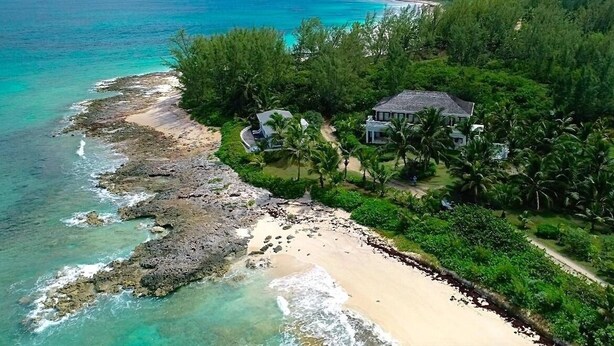 A coastal property with a beach, rocky shoreline, and lush greenery. - Private Beachfront Home w/Pool, Solar, Banks Rd, Walk to Restaurants (Governors Harbour)