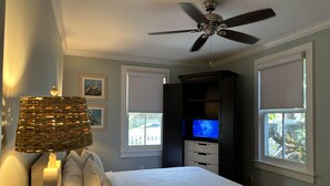 A bedroom with a bed, a ceiling fan, a television, and a window with blinds. - STARS ~ 4 bedroom, 2 Bath Condo, Shared Heated Pool, Downtown Location! (Key West)