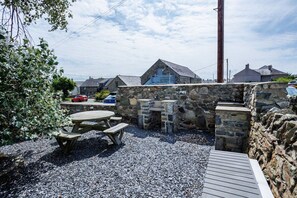 Garden seating area for al fresco relaxation, wheelchair accessible holiday cottage for up to three pets, Aberffraw, Anglesey