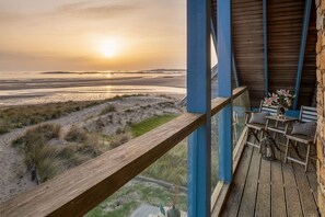 Golden sunset from the first floor balcony of Niwl Y Mor, beachfront pet-friendly holiday home on Porth Crigyll, Rhosneigr, Anglesey - Niwl Y Mor: Beachfront Rhosneigr cottage for 6 guests (Rhosneigr)
