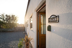 Ysgubor name sign on the wall, The Granary pet-friendly holiday cottage at Glan Gors Farm, Bryn Du, Anglesey