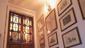 A staircase with a wooden door and stained glass windows, leading to a room with framed pictures on the walls. - TORRE DEL CAMPO - Two Bedroom Apartment, Sleeps 2 (Siena)