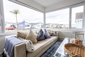 Relax in this inviting living room with a sofa, coffee table, and beautiful views.