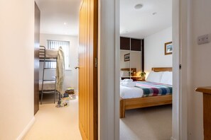 First floor hallway connecting four bedrooms and family bathroom, upside-down holiday home in Rhosneigr, Anglesey