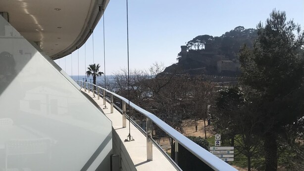 A balcony with a metal railing overlooking a cityscape. - BEACH APARTMENT 3 in TOSSA DE MAR (Tossa de Mar)