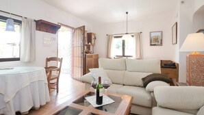 A cozy living room with a glass table, a sofa, and a dining area. - Self catering Cortijo Algabia for 4 people (Alhendín)