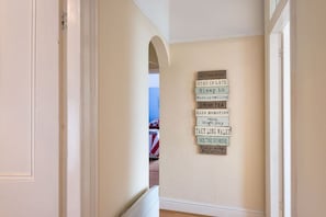Internal hallway connecting bedrooms and living spaces, beachside holiday apartment in Rhosneigr, Anglesey - Bryn Awel: A three bed flat in Rhosneigr with sea views (Rhosneigr)