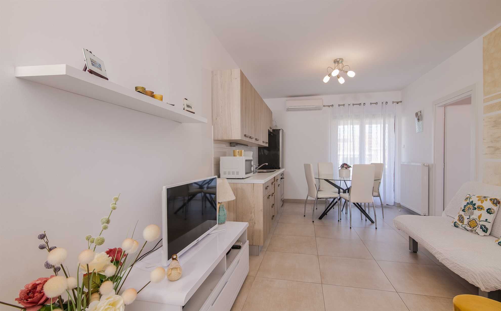 A modern apartment with a living room, kitchen, and dining area.