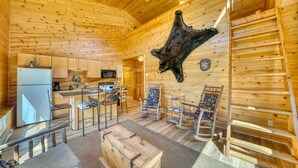 A log cabin interior with a kitchen, dining area, and a mounted animal hide. - Horse Ranch on the Yellowstone River. Close to Gardiner and Yellowstone Park. (Emigrant)
