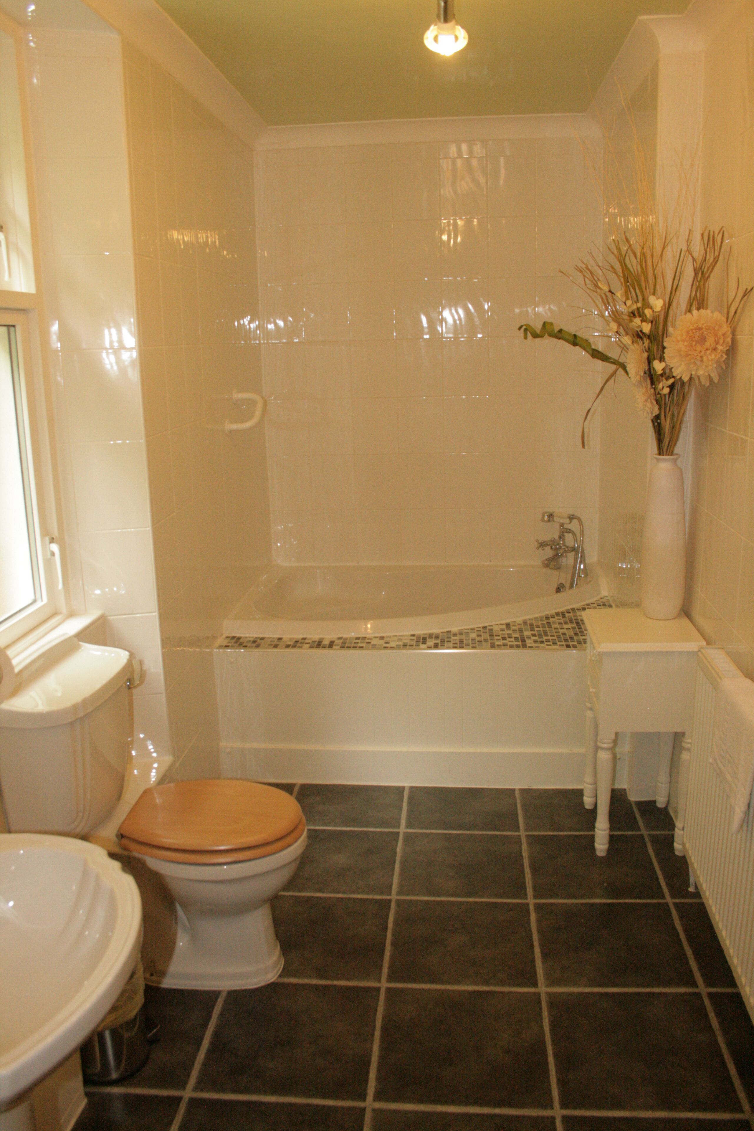 A bathroom with a bathtub, toilet, and sink.