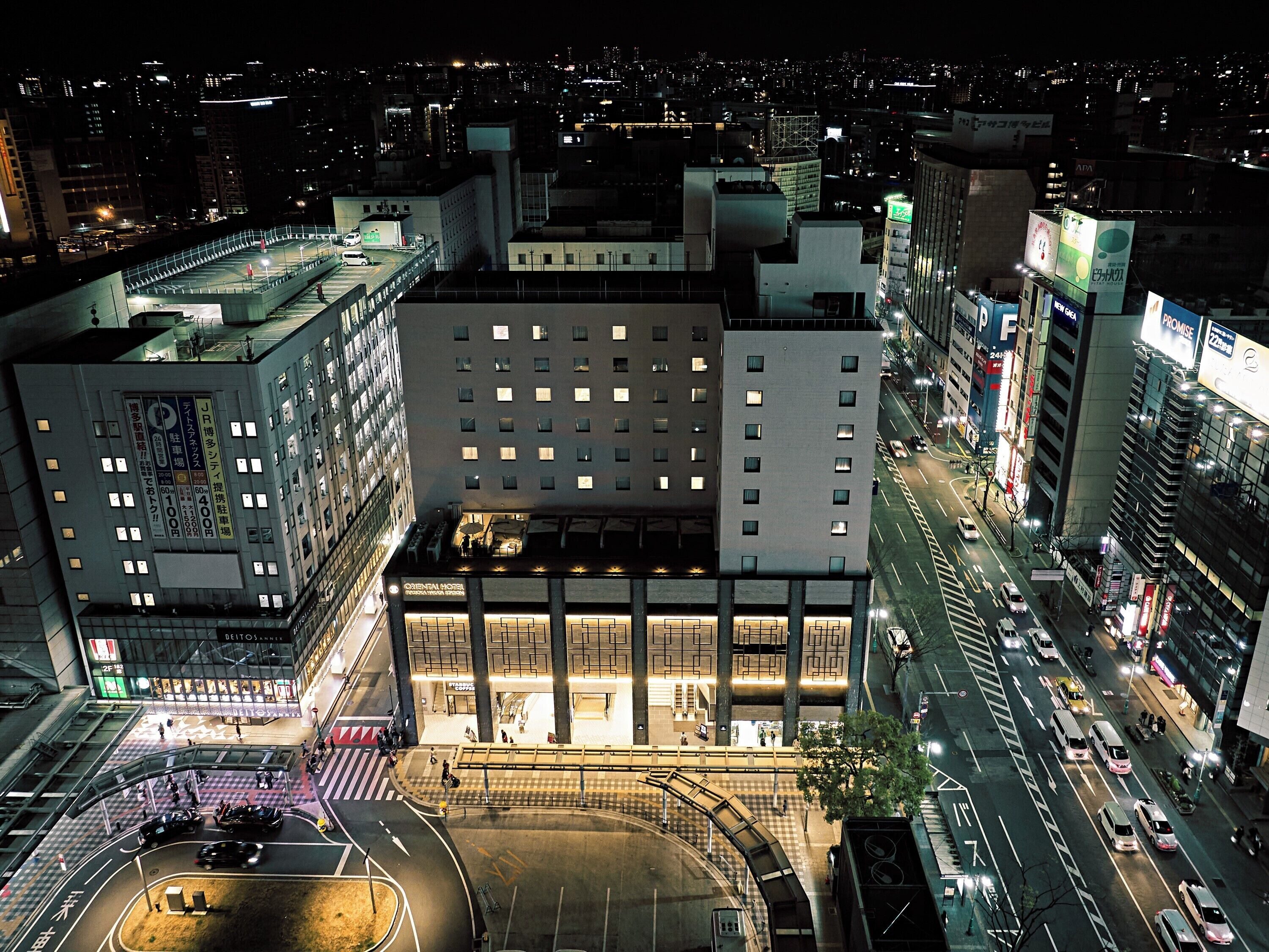 A hotel with multiple floors, a central atrium, and a parking area.