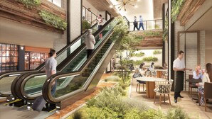 A modern indoor space with an escalator, seating areas, and greenery. - Oriental Hotel Fukuoka Hakata Station (Fukuoka)