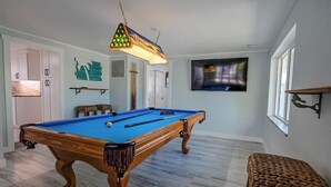A pool table in a room with a television mounted on the wall and a window. - For those who want ONLY THE BEST!  60 Steps to the Beach - Gulf Views! (Manasota Key)