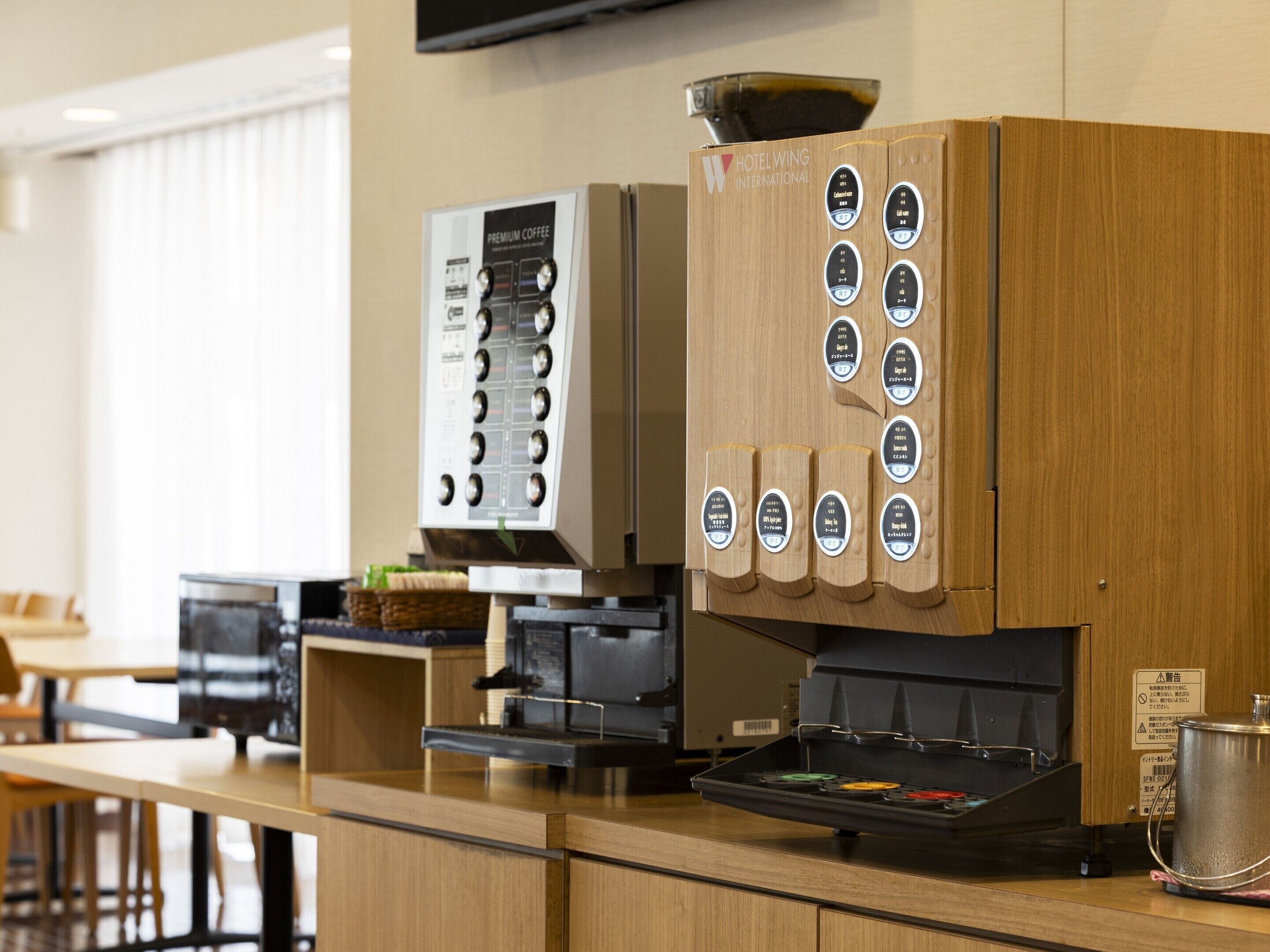 A coffee machine and a coffee dispenser in a hotel setting.