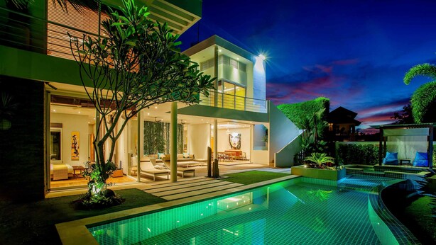 A modern two-story house with a swimming pool, large windows, and outdoor seating. - Phocea Golf View Villa by Premier Hospitality Asia (Pecatu)