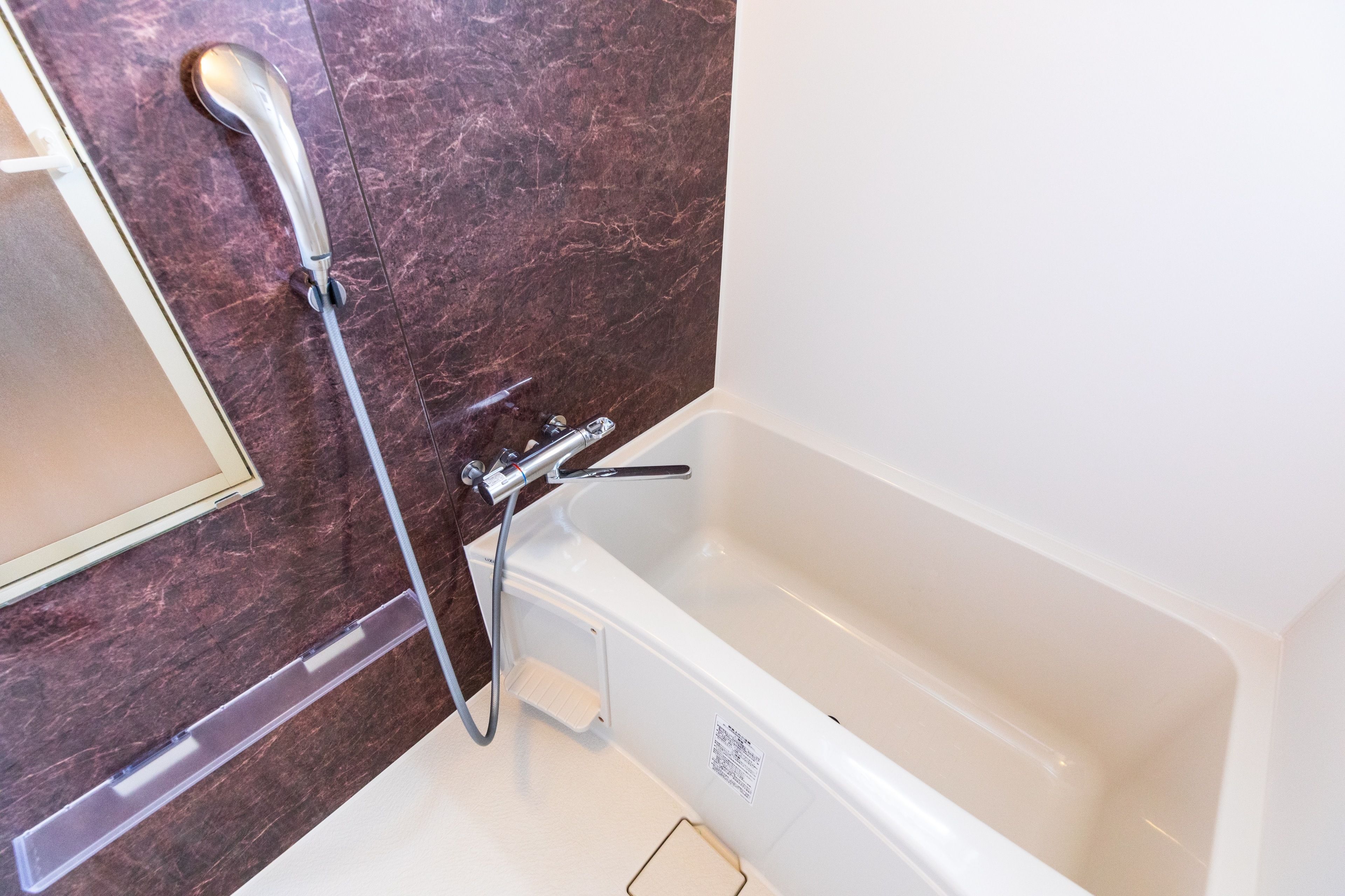 twin room | bathroom | separate bathtub and shower, deep-soaking bathtub, hair dryer, slippers