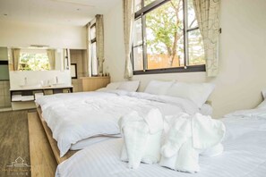 A hotel room with a large bed, a bedside table, a mirror, and a window with curtains. - shih.kuang (Tainan)