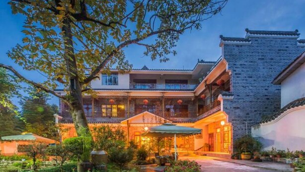 A traditional building with multiple balconies and a well-lit entrance. - Floral Hotel Chengdu Dujiangyan (Chengdu)