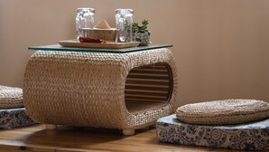 A room with a large window, a woven pouf, a glass table with a tray, and a patterned pouf. - Floral Hotel Chengdu Dujiangyan (Chengdu)