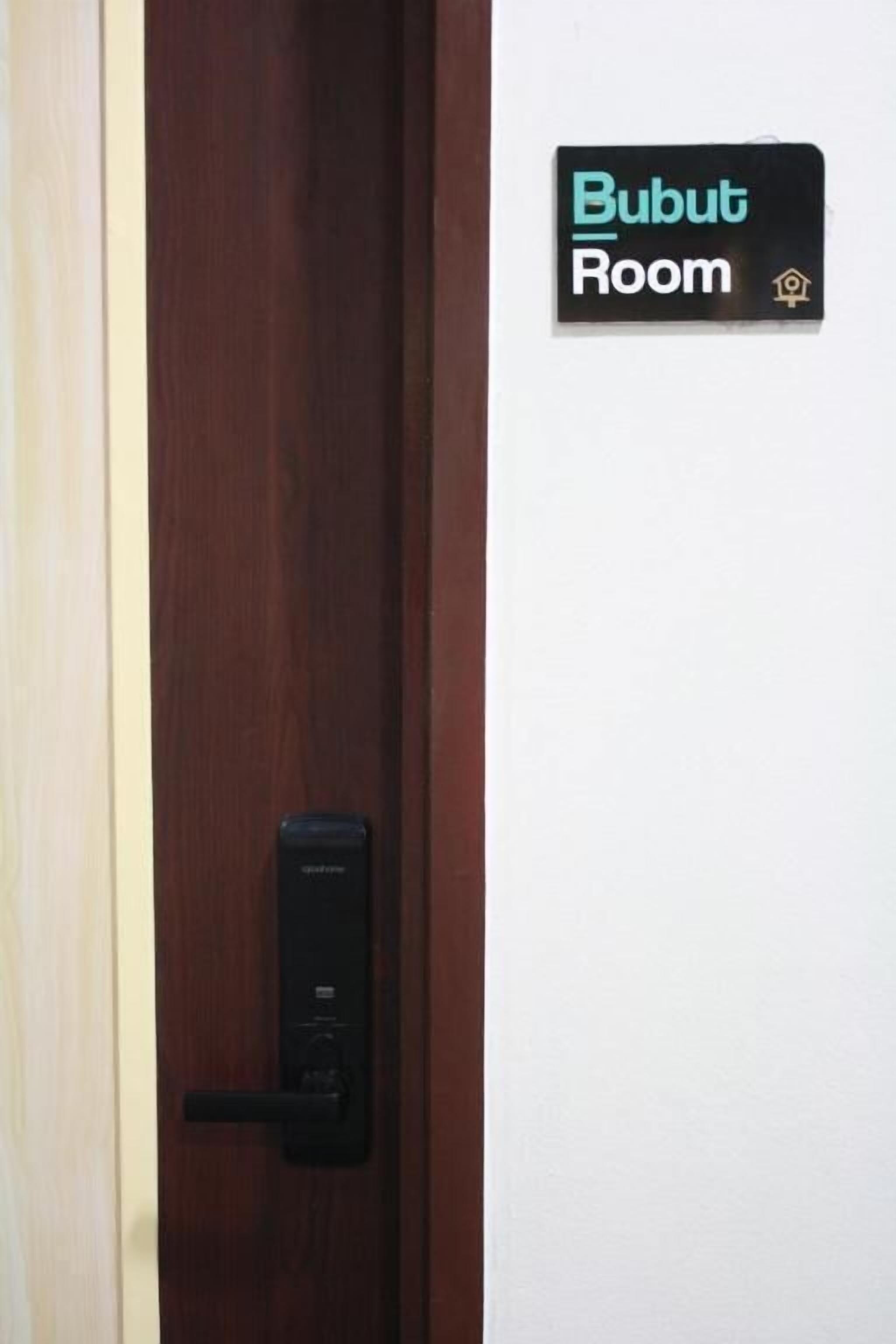 A door with a digital lock and a sign indicating "Bubut Room".